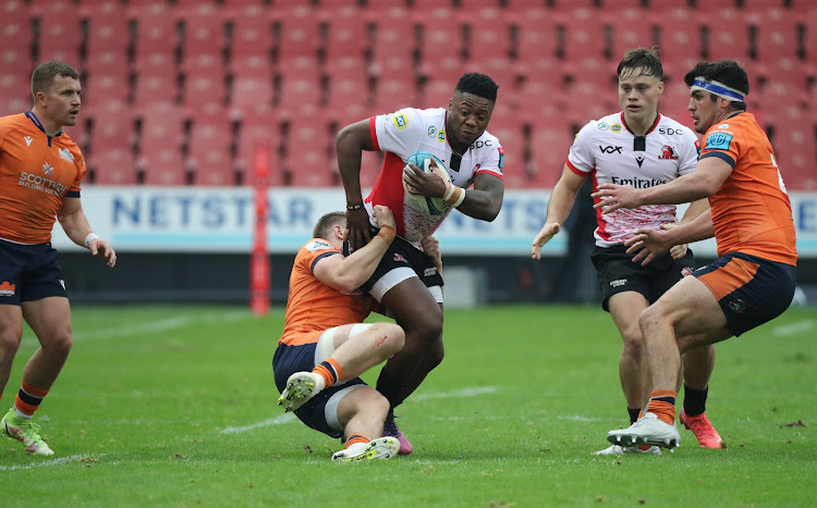 Wandisile Simelane of the Lions is tackled by James Lang of Edinburgh during their Vodacom United Rugby Championship match at Ellis Park.