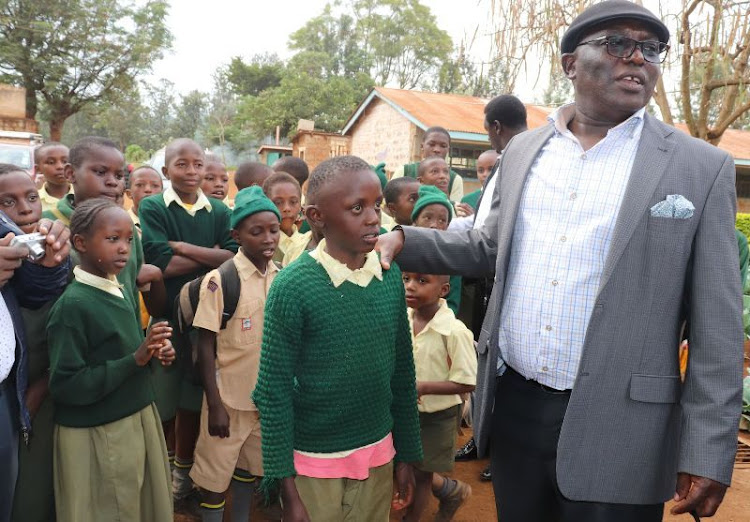 Manyatta MP John Muchiri with St Michael Primary School's pupils on Friday.