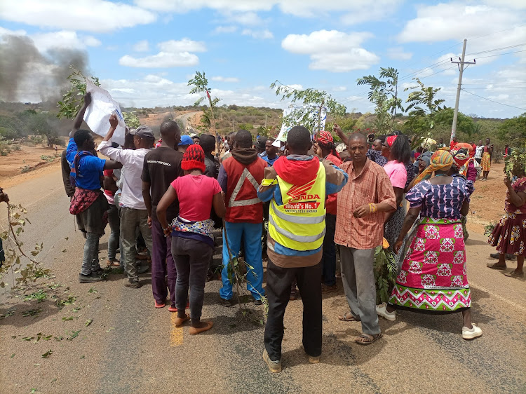 Supporters of David Muema Nduku protest along the streets of Kamuwongo market on Monday.