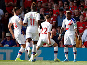 Crystal Palace's Patrick van Aanholt celebrates with teammates after scoring the winning goal in a 2-1 Premier League victory over Manchester United at Old Trafford on August 24 2019. 