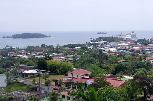 Roger W: "Part of Limon, Costa Rica, with the Caribbean Sea from El Faro restaurant, at the top of a hill overlooking Limon. Isla Uvita, where Christopher Columbus landed in his fourth and last voyage to the New World in 1502, is at the far left. Celebrity Equinox, our cruise ship, is at the right."