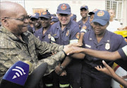 MOBBED: President Jacob Zuma is
mobbed by admiring Roodepoort fire
station workers yesterday. He visited two staffers attacked while
responding to an emergency. Pic: Veli Nhlapo. 14/03/2010. © Sowetan.