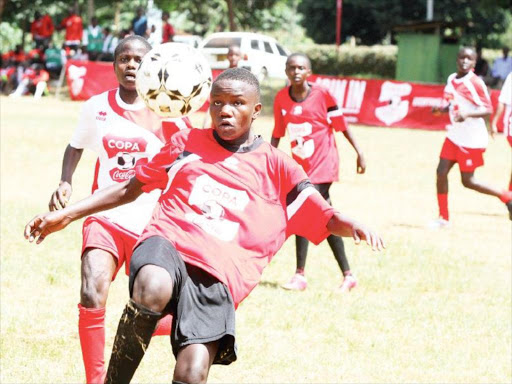 Olympic High School’s Pauline Akoth (left) vies for the ball against Colleta Awuor of Passenga /CONSOLATA MAKOKHA