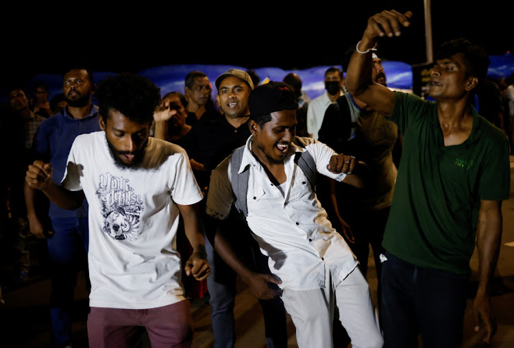 People dance as they celebrate the resignation of Sri Lanka’s President Gotabaya Rajapaksa at a protest site, amid the country’s economic crisis, in Colombo, Sri Lanka July 14, 2022.