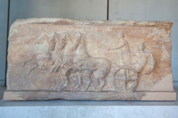 A relief of an ancient dedication at the Acropolis Museum in Athens. 