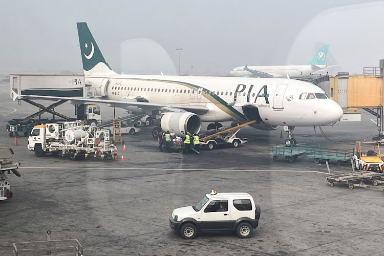 View of a Pakistan International Airlines passengers plane, taken through a glass panel, at the Allama Iqbal International Airpor in Lahore, Pakistan. File photo: AKHTAR SOOMRO/REUTERS