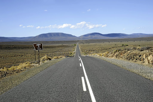 Highway passing through the Central Karoo region of SA near Matjiesfontein looking toward the Komsberge Mountains.