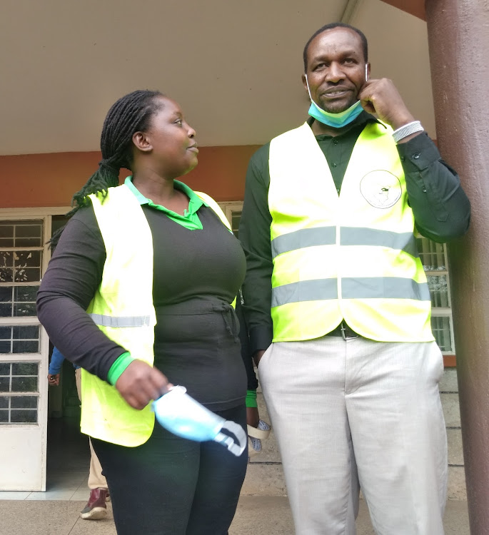 Voter educator Janet Mwende and Narok North constituency election coordinator John Taiswa (right) at the IEBC offices on Thursday.