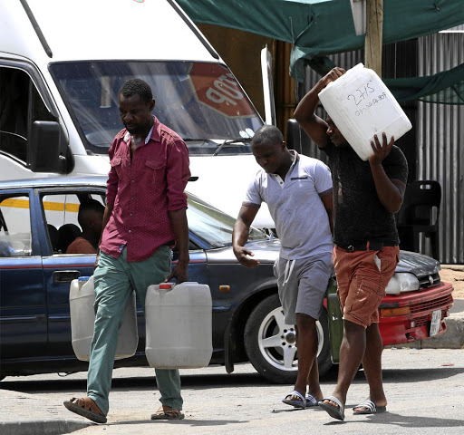 Zimbabweans going home after filling up their drums with petrol at a garage near Beit Bridge in Musina, Limpopo, because of the petrol crises in their country.