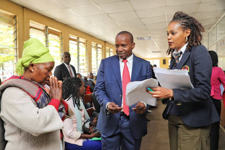 Interior CS Kithure Kindiki interacting with a lady at Nyayo House on September 14, 2023