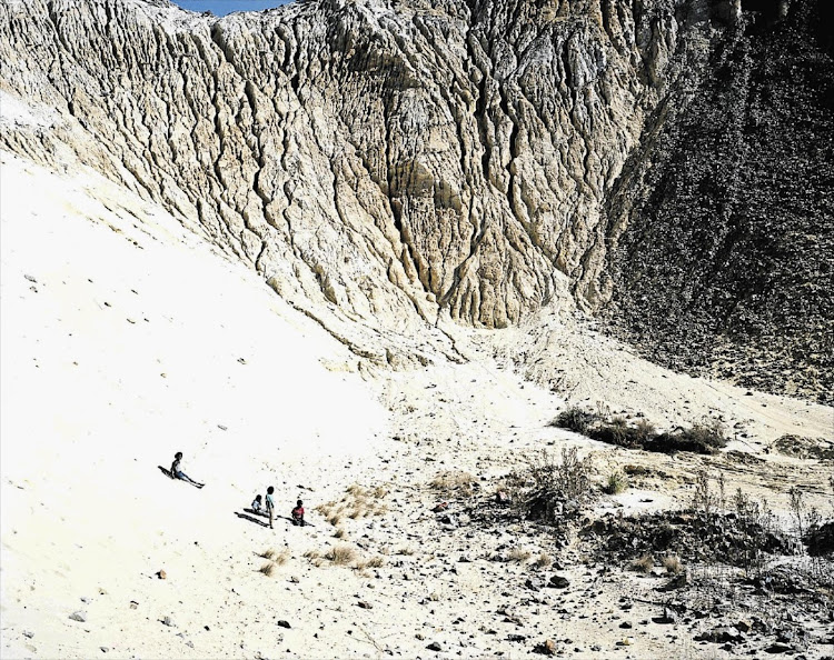 Children play on the Riverlea mine dump near their homes in a low-cost housing development. File photo.