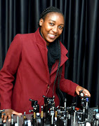 Nokwazi Mphuthi poses for a picture at a laboratory.