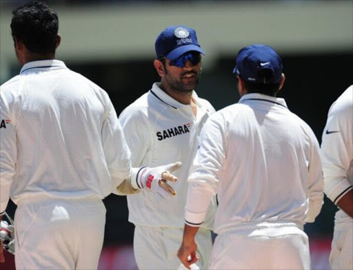 Indian captain Mahendra Singh Dhoni (C) celebrates with teammates, at the end of the first test match between West Indies and India at Sabina Park in Kingston, Jamaica, June 23, 2011. India won by 63 runs