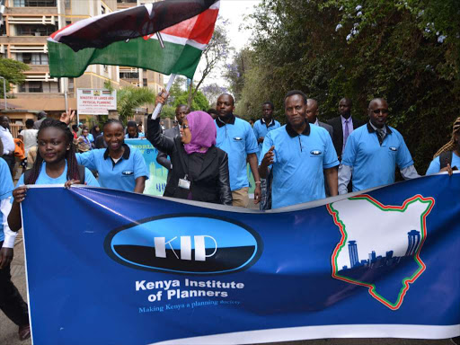 Lands CS Jacob Kaimenyi(c) during world town planning day at Crown plaza in Nairobi yesterday.Photo Gilbert Koech