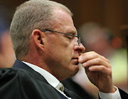 State Prosecutor Gerrie Nel reacts as he listens to the verdict in the trial of Olympic and Paralympic track star Oscar Pistorius at the high court in Pretoria September 12, 2014. Pistorius was convicted of culpable homicide on Friday. REUTERS/Siphiwe Sibeko