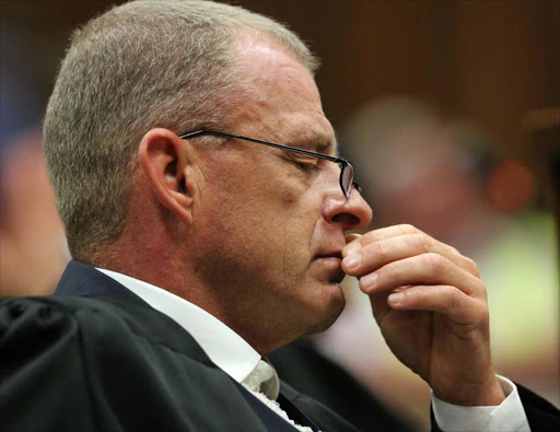 State Prosecutor Gerrie Nel reacts as he listens to the verdict in the trial of Olympic and Paralympic track star Oscar Pistorius at the high court in Pretoria September 12, 2014. Pistorius was convicted of culpable homicide on Friday. REUTERS/Siphiwe Sibeko