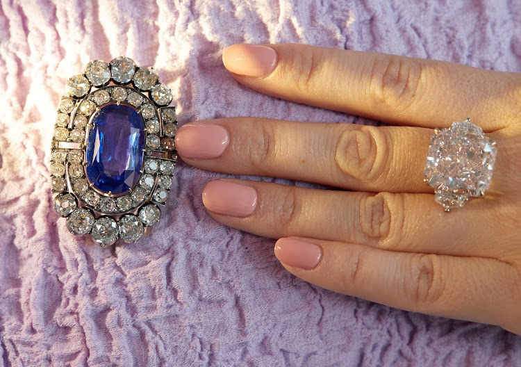 A historically valuable sapphire and diamond brooch and an orange-pink diamond ring weighing 25.62 carats at a preview at Sotheby's before their auction sale in Geneva.