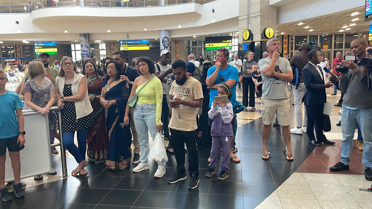 People wait at OR Tambo International Airport in Johannesburg for their families and friends to return home. Picture: SUPPLIED.