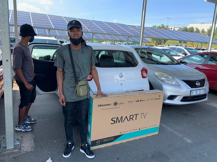 Oarabile Kotsitswe with his TV purchased in Johannesburg this morning.