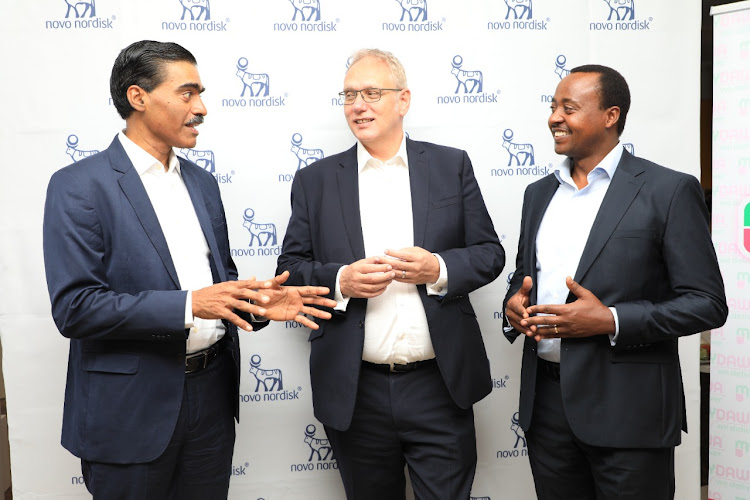 Vinay Ransilwal, Tony Wood and Francis Njau pose for a photo after the launch on April 22, 2022