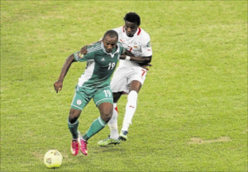 Talent: Nigeria's Sunday Mba and Burkina Faso'S Florent Rouamba Battle For the Ball In the Afcon final. Photos: Veli Nhlapo
