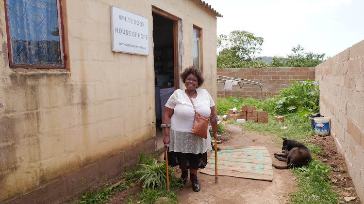 Mavis Nkosi, a community activist, poses for a photo in front of a shelter she helps run for abused women in Welbedacht.