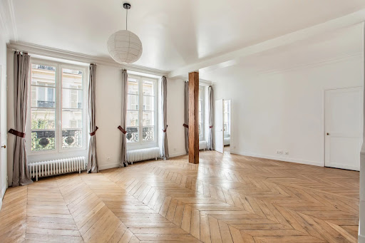 Luxury property for sale in Paris 9ème (75009) - Large living room herringbone parquet, wood beam