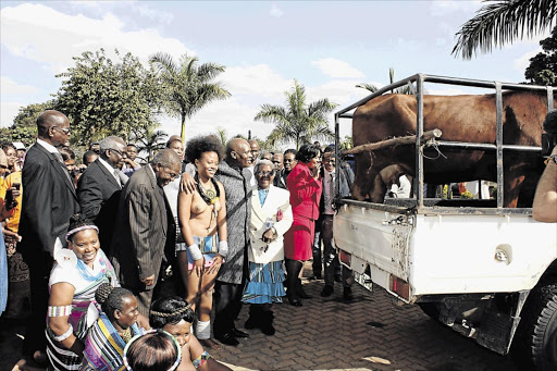 SABC boss Hlaudi Motsoeneng with a “wife” and cow that were presented to him as gift by Venda traditional leaders. Picture: Sowetan