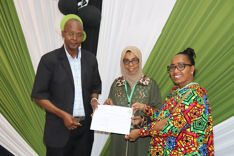 Former Taita Taveta governor John Mruttu and his running mate Janet Oben receive clearance certificate from IEBC's Eisha Mohamed at the Taita Taveta University on June Monday