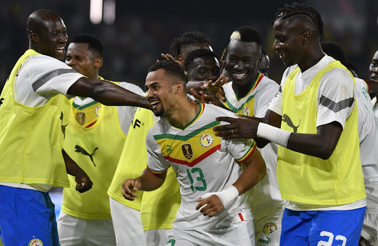 Iliman Cheikh Baroy Ndiaye of Senegal celebrates his goal with teammates during the Africa Cup of Nations match against Guinea at Charles Konan Stadium in Yamoussoukro.