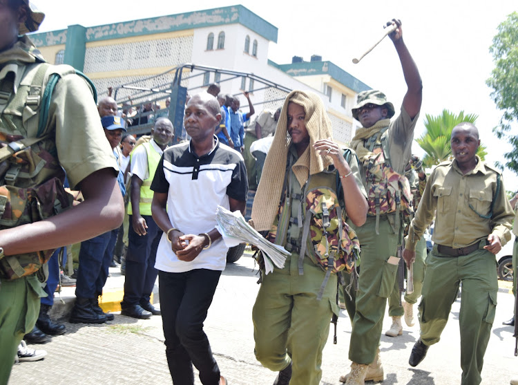 Cult leader Paul Mackenzie is being led to Mombasa Law Courts.