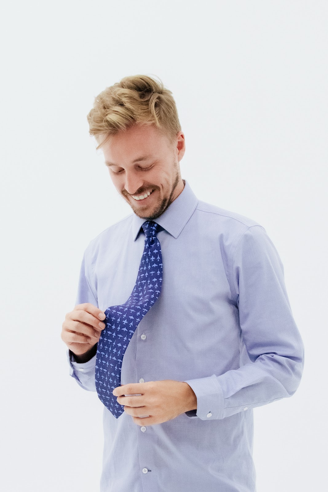 Man looking down at tie