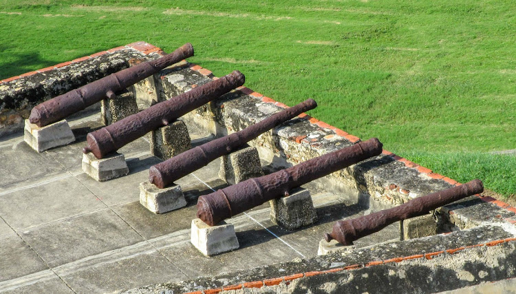 Cannons atop a battlement on Castillo San Felipe de Barajas in Cartagena, Colombia. 