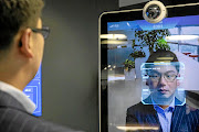 Xu Li, CEO of SenseTime Group, is identified by the company's facial-recognition system on a screen at SenseTime's showroom in Beijing. Facial recognition technology could soon be used to  collects a database of information on ordinary citizens.