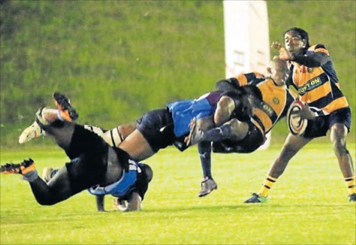 UNFAIR ODDS: Odwa Rasmeni of Police gets crash-tackled during the game against Cambridge at the Old Selbornian club. Picture: SINO MAJANGAZA