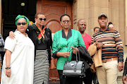 Karabo Mokoena's family with MEC of social development Nandi Mayathula-Khoza outside the Johannesburg High Court during the recess of the case proceedings. / PMduduzi Ndzingi