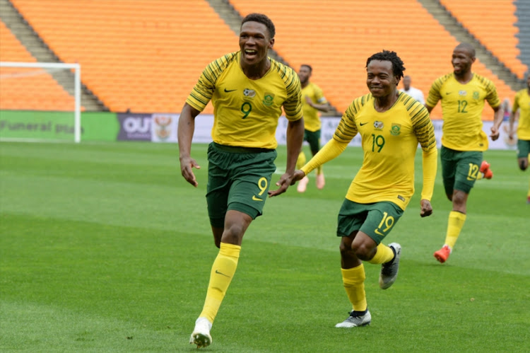 Lebo Mothiba of South Africa celebrates scoring a goal with Percy Tau during the 2019 Africa Cup of Nations qualification match between South Africa and Seychelles at FNB Stadium on October 13, 2018 in Johannesburg, South Africa.