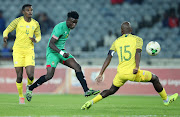 Hagiazo Magaya of Zimbabwe challenged by Tercious Malepe and Teboho Mokoena of South Africa.