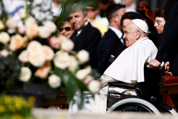 Pope Francis arrives to attend the Easter Sunday mass at St Peter's Square at the Vatican on April 9 2023.