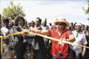 RIBBON CUTTING: Westonaria municipality Mayor Maserane Khumalo and Dr Nobs Mwanda with an unknown official opening the park at Waterworks informal settlement on the West Rand. PHOTO: MUNYADZIWA NEMUTUDI