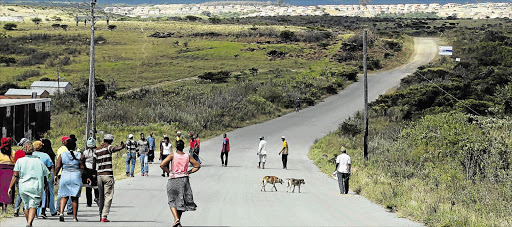 TEETHING PROBLEMS: Some of the new residents in the freshly launched RDP development in Reeston are seen here walking back to their new homes after protesting against the taxi association that operates in the area Picture: ALAN EASON