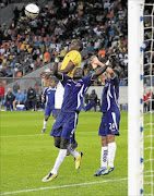 HEADS UP: Mamelodi Sundowns striker Nyasha Mushekwi, top, goes for a header against Maritzburg United's Mor Diouf, left, and Peter Petersen during their Premiership match at Nelson Mandela Bay Stadium in Port Elizabeth on Saturday. Photo: Gallo Images