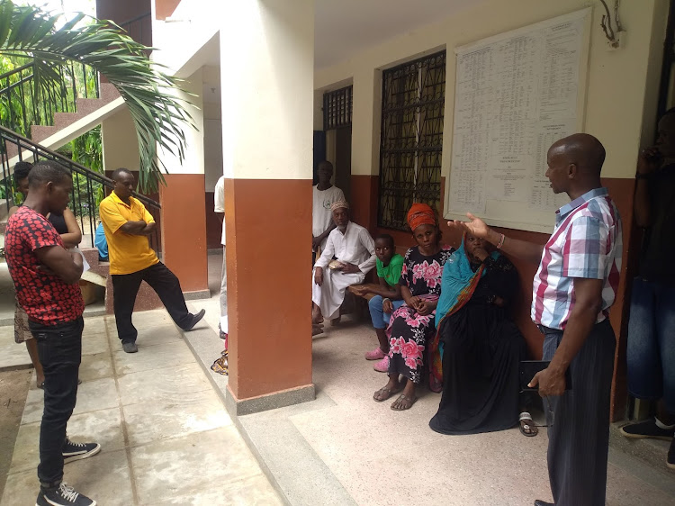 Kisauni Primary School head teacher Joshua Kuria talks to parents on Wednesday