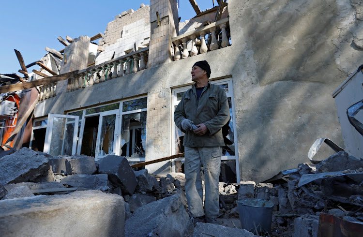 A man removes debris of a building destroyed by recent shelling during Russia-Ukraine conflict in the city of Kadiivka in the Luhansk region, Ukraine, September 19 2022. Picture: ALEXANDER ERMOCHENKO/REUTERS