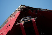 A view of the landmark red windmill atop the Moulin Rouge, the famous Paris cabaret club, after its sails fell off during the night on April 25 2024. 