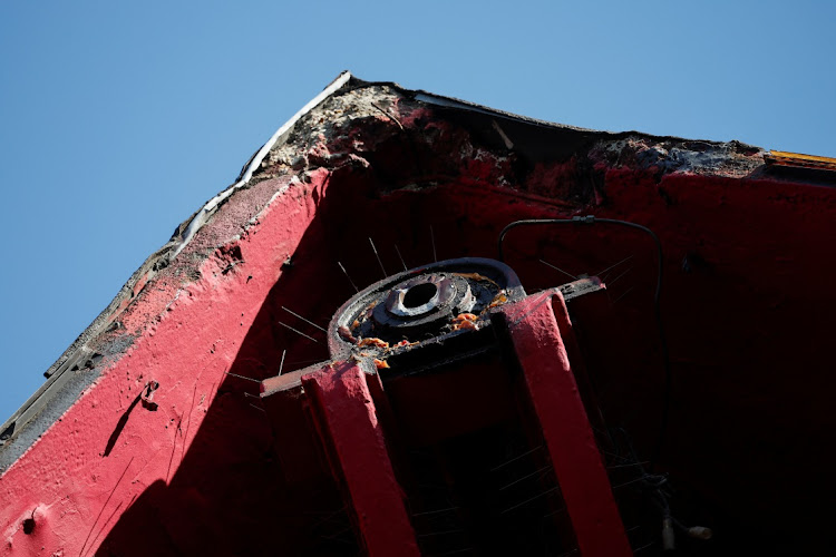 A view of the landmark red windmill atop the Moulin Rouge, the famous Paris cabaret club, after its sails fell off during the night on April 25 2024.