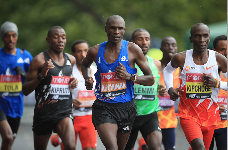 Kenya's Vincent Kipchumba runs alongside compatriots Eliud Kipchoge (R) and Bernard Kipruto