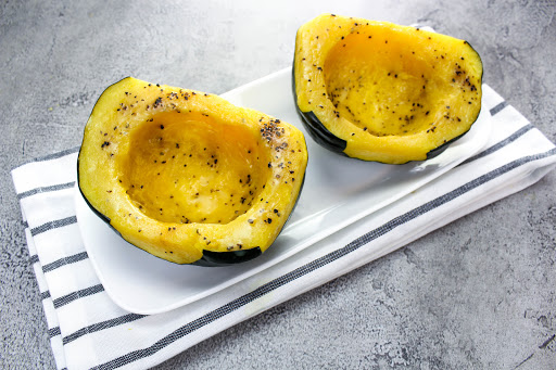 Two halves of acorn squash on a plate.