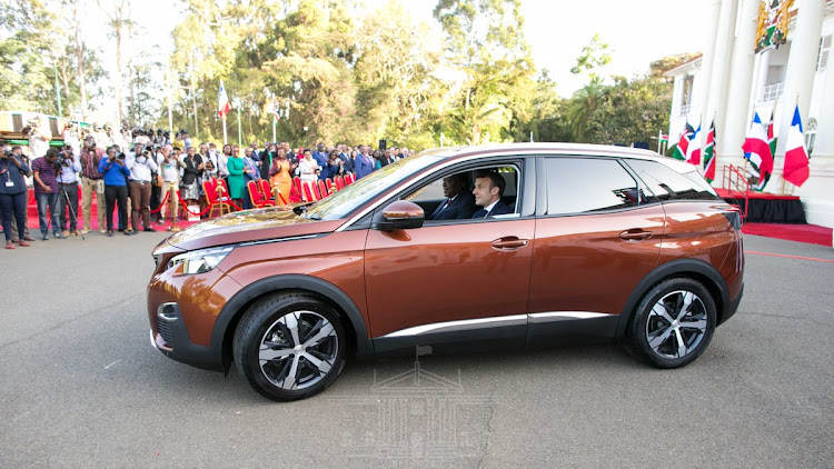 President Uhuru Kenyatta and his French counterpart Emmanuel Macron when they unveiled the Kenyan assembled Peugeot 3008 at State House, Nairobi.