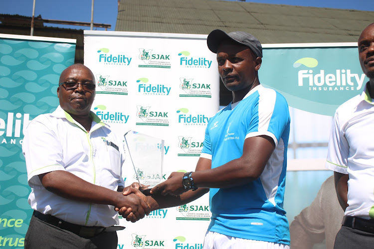 Western Stima coach Salim Babu receives the September Coach of the Month plaque from Fidelity Insurance Regional manager Sammy Chirchir at Moi Stadium, Kisumu.